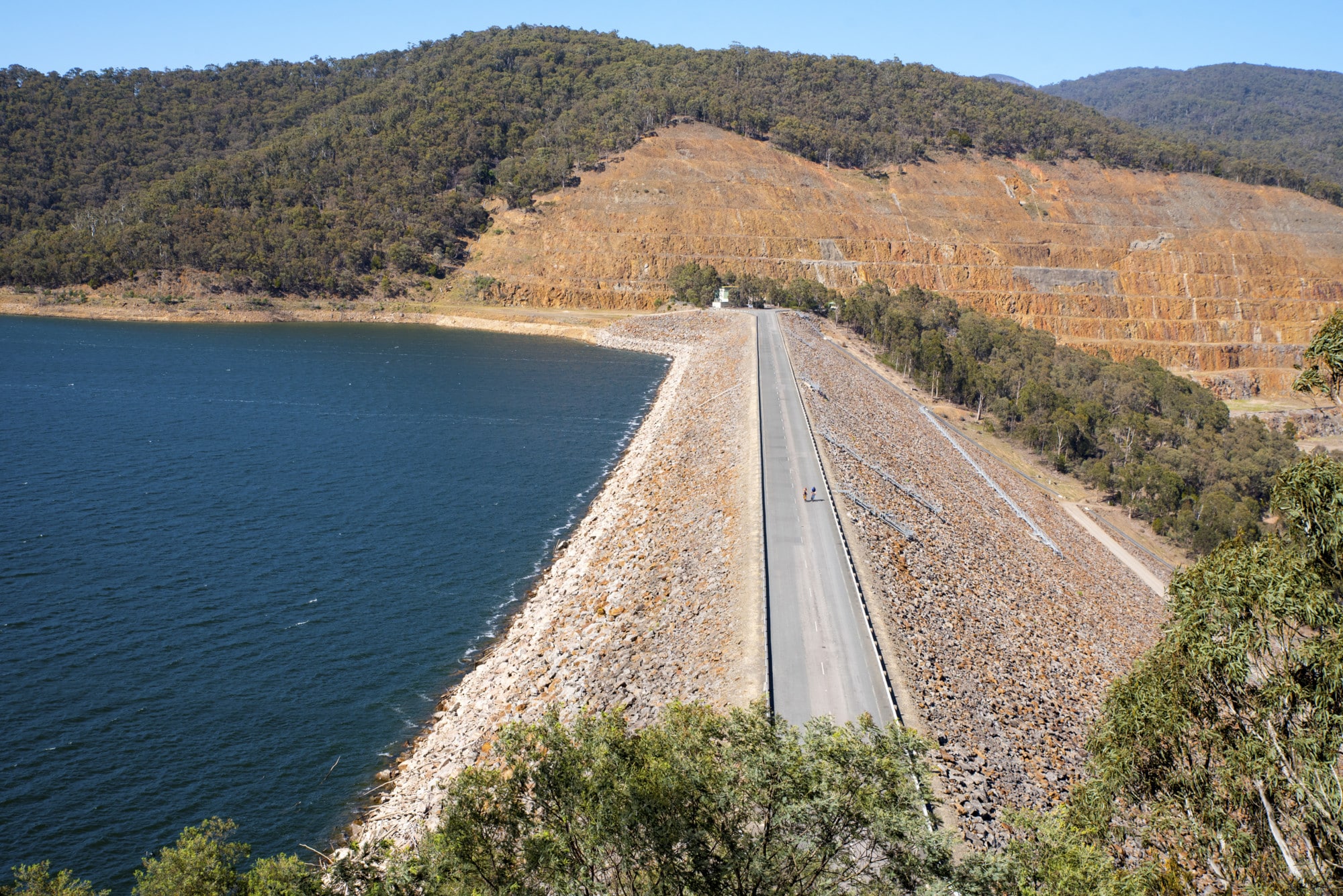 Two cyclists cycling over the Lake Dartmouth dam wall