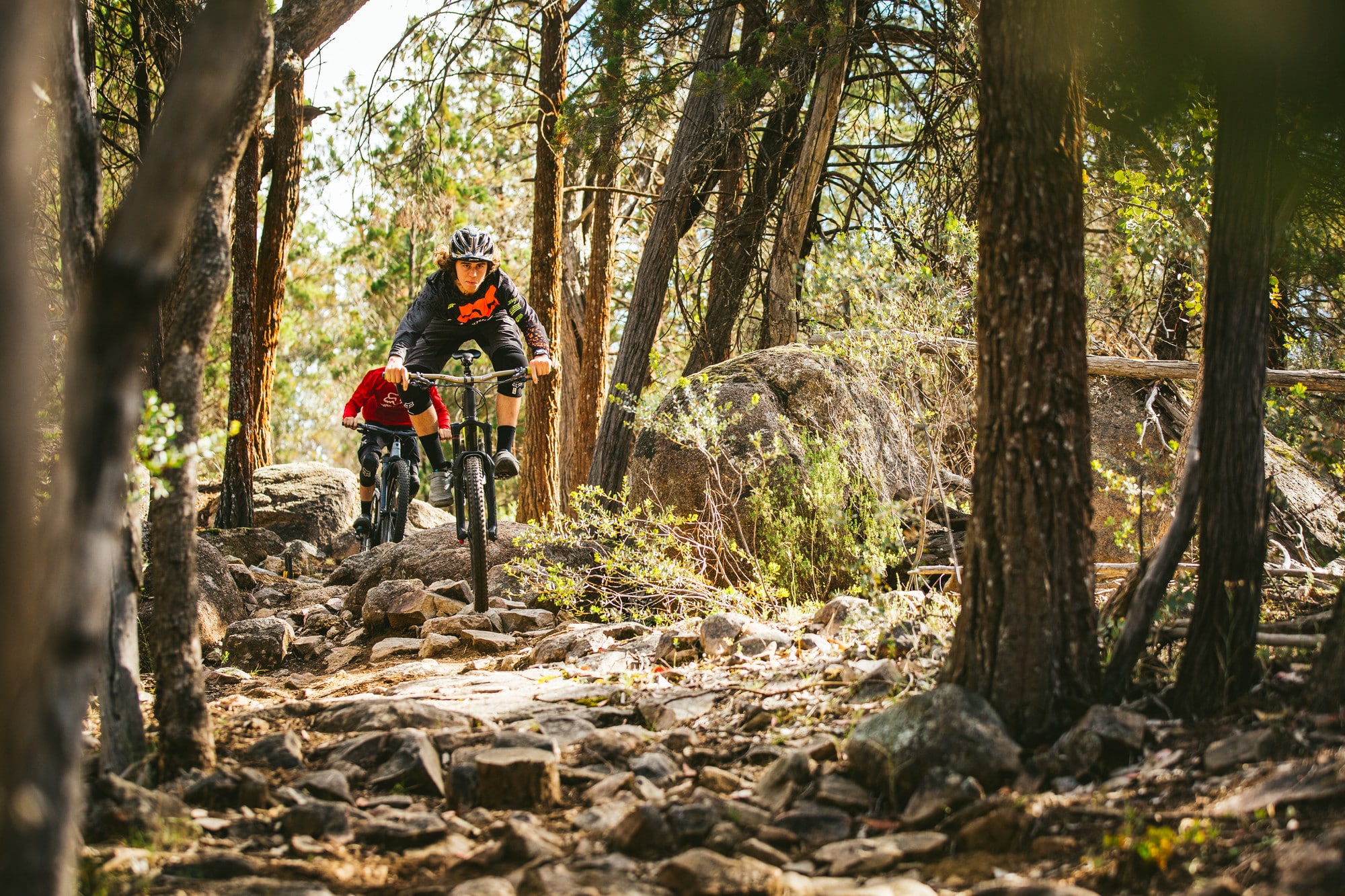 Two cyclists taking on Beechworth Mountain Bike Park's technical granite trails