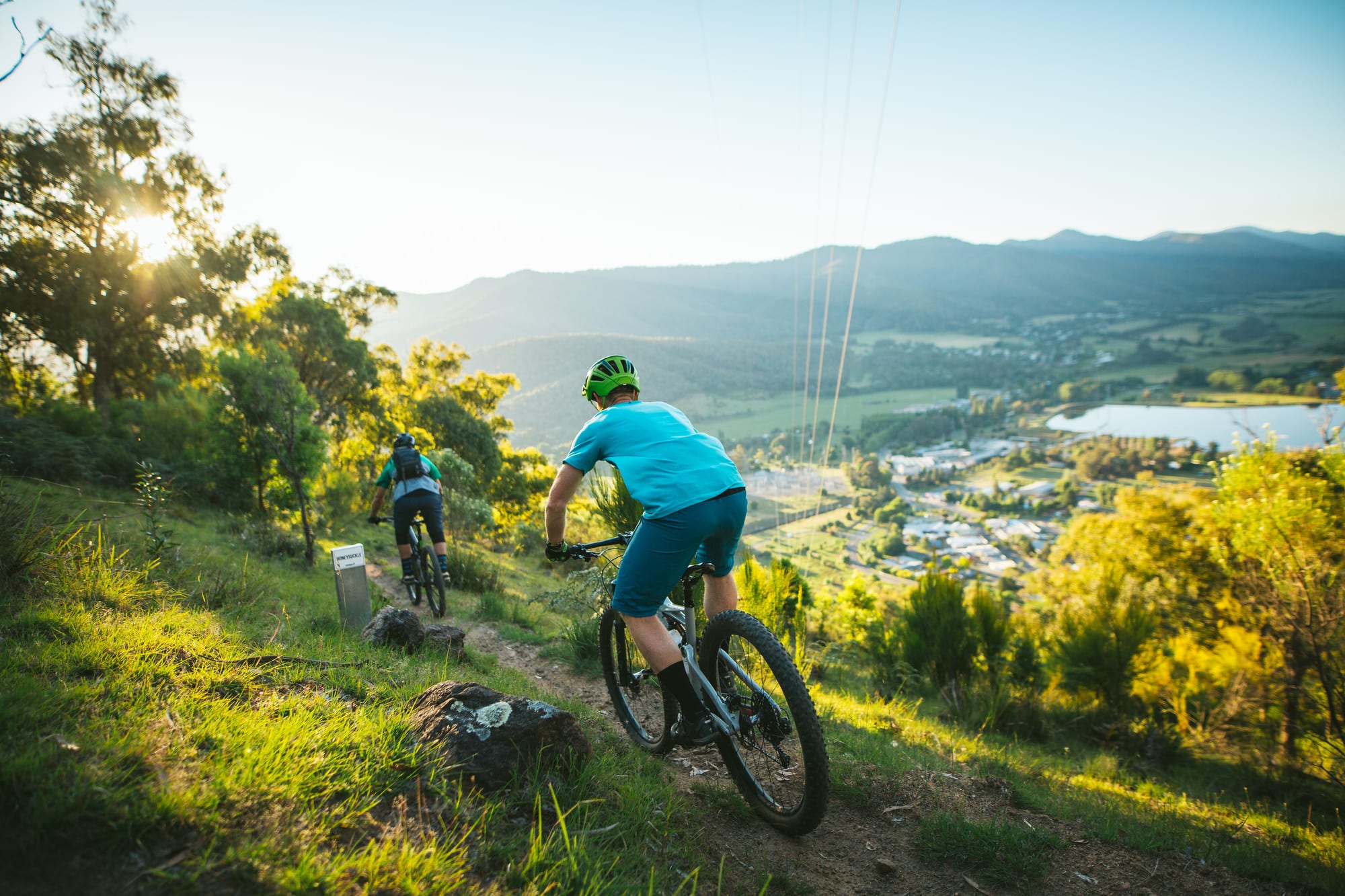 Two cyclists riding past breathtaking views at Big Hill Mountain Bike Park in Mount Beauty