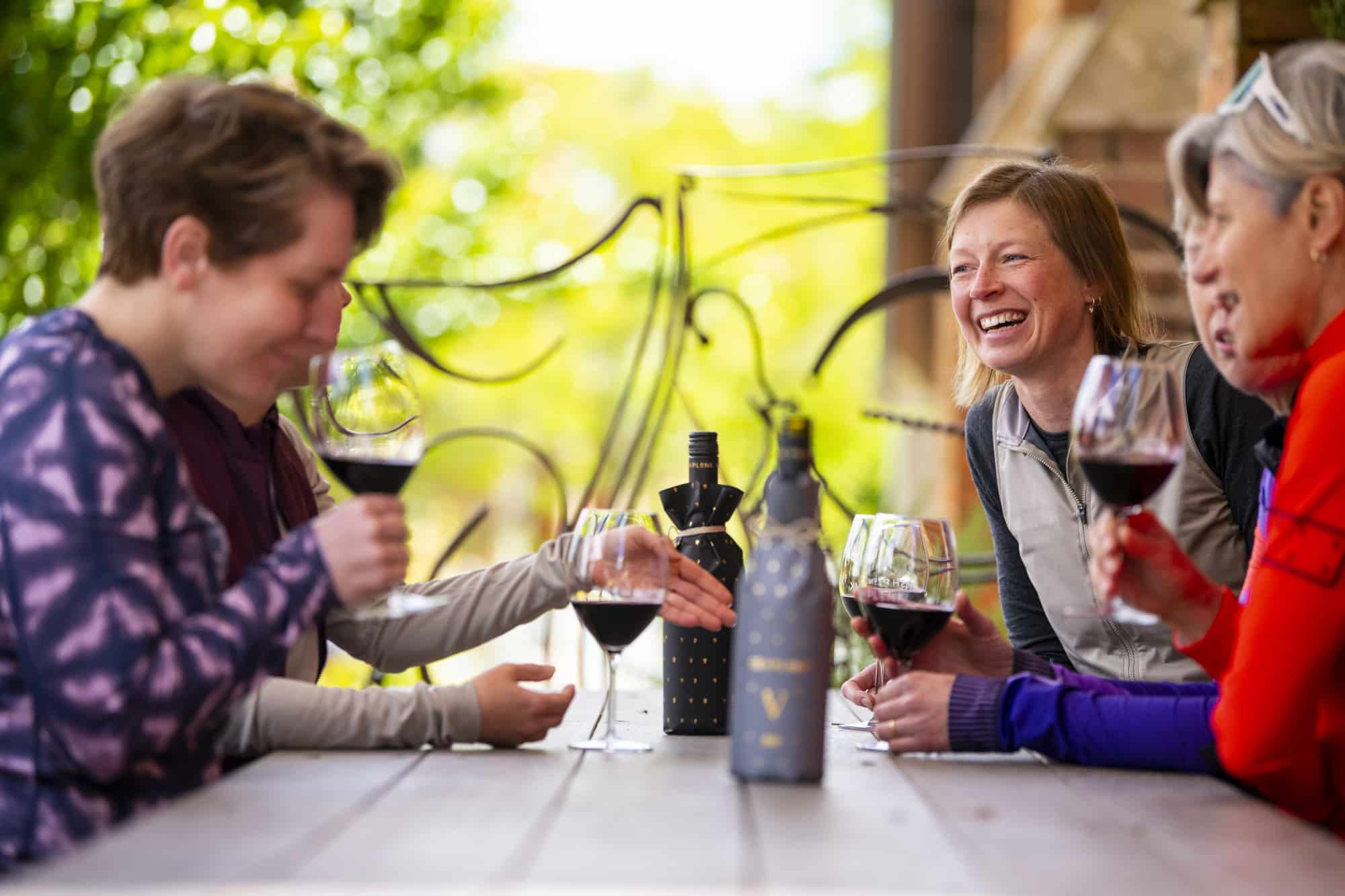 Group of cyclists sipping wine at Posh Plonk in Chiltern