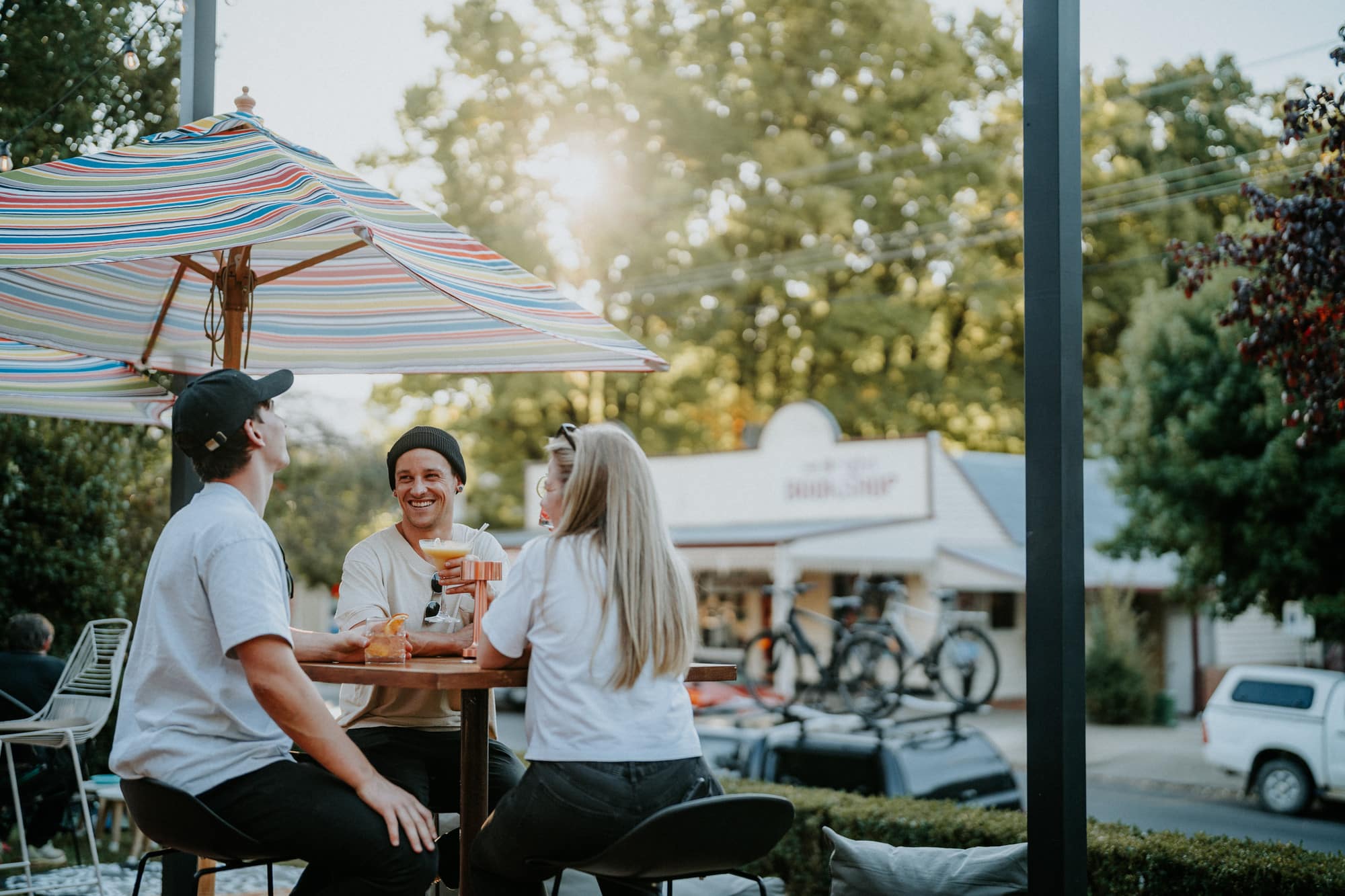 Three people enjoying drinks at The Yard at Elm Dining in Bright