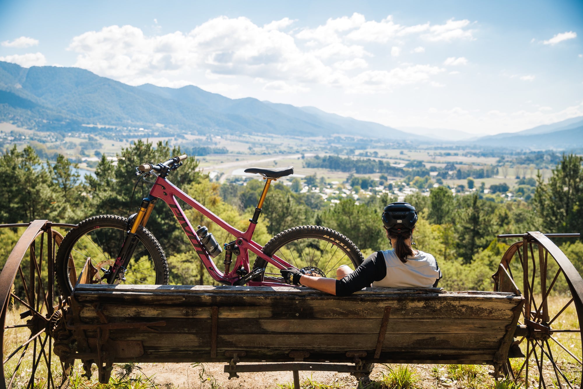 Cyclist sitting in “Whipps Design” chair looking at the view at Big Hill MTB Park in Mount Beauty