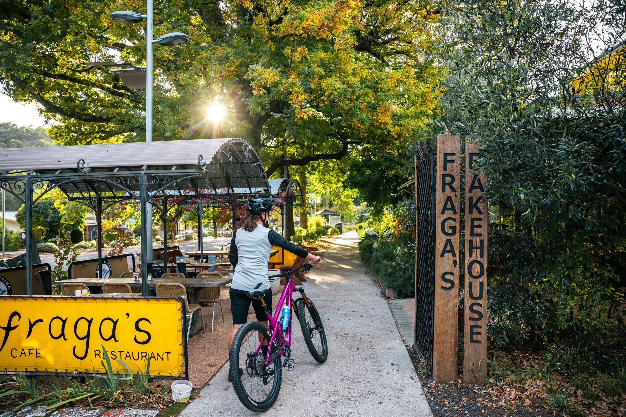 Cyclist walking through Marysville with their mountain bike