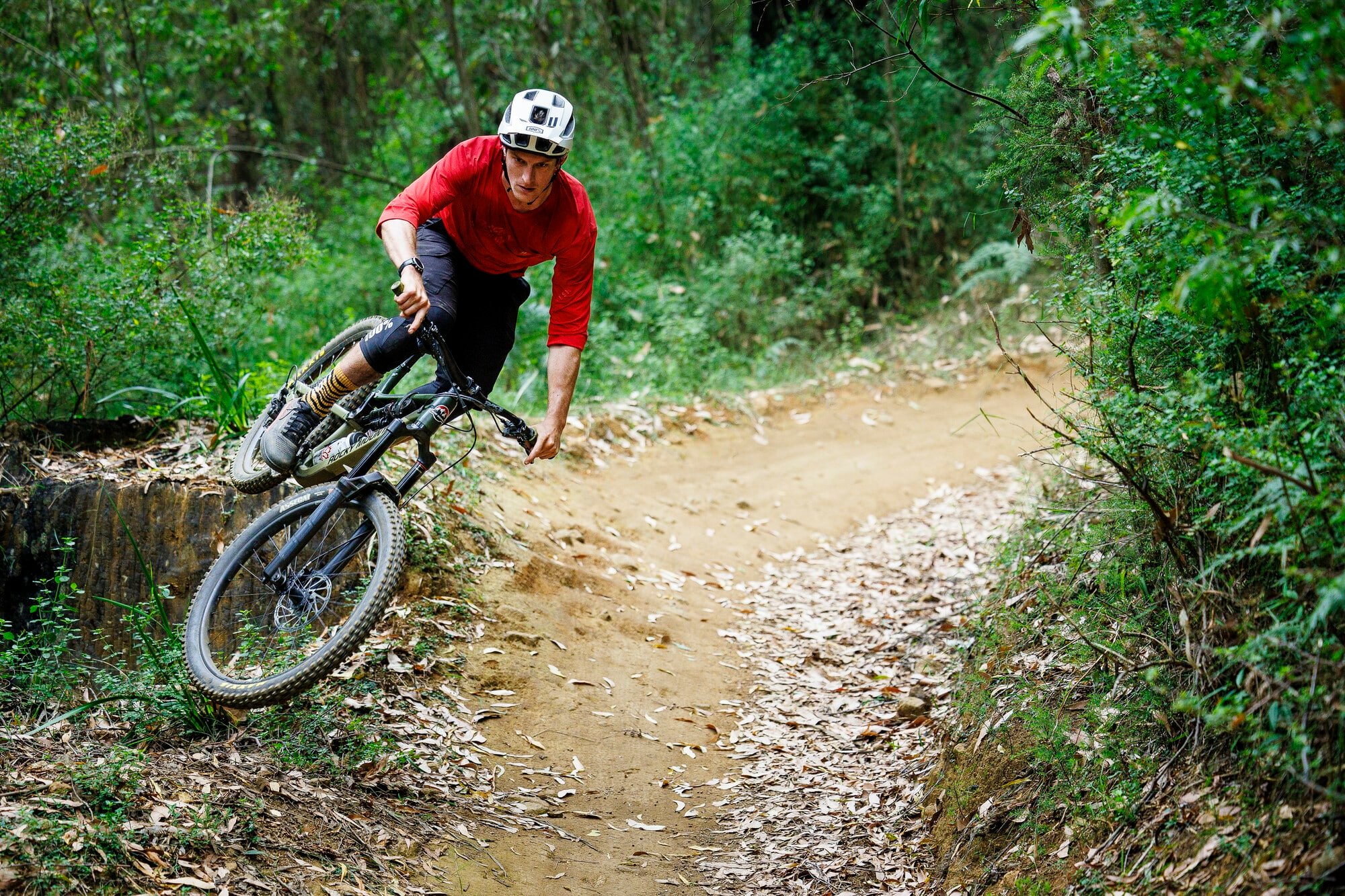 Cyclist riding berms at Lake Mountain Bike Park