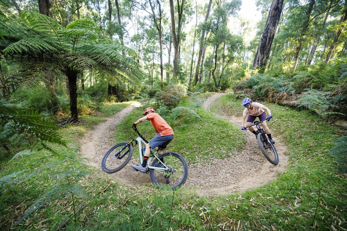 Two mountain bikers riding Buxton Mountain Bike Park's berms