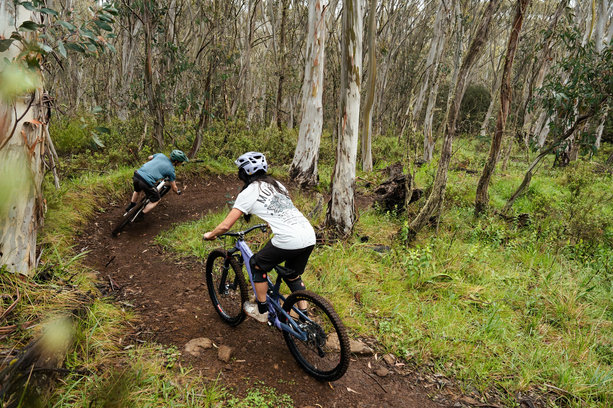 Cyclists riding alpine loam berms at Dinner Plain MTB Park