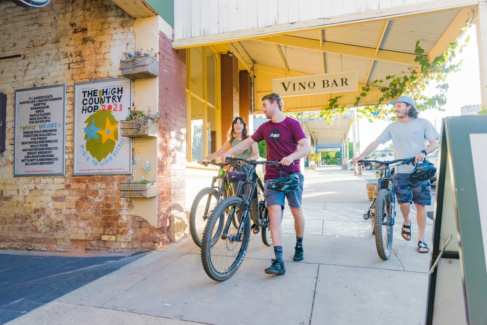 Cyclists pushing their bikes through historic gold-rush town Beechworth