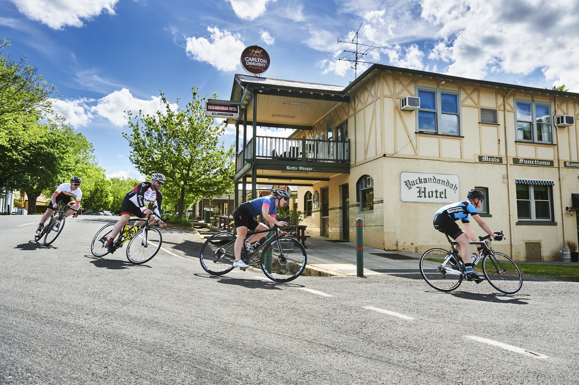 Group of road cyclists riding through Yackandandah township