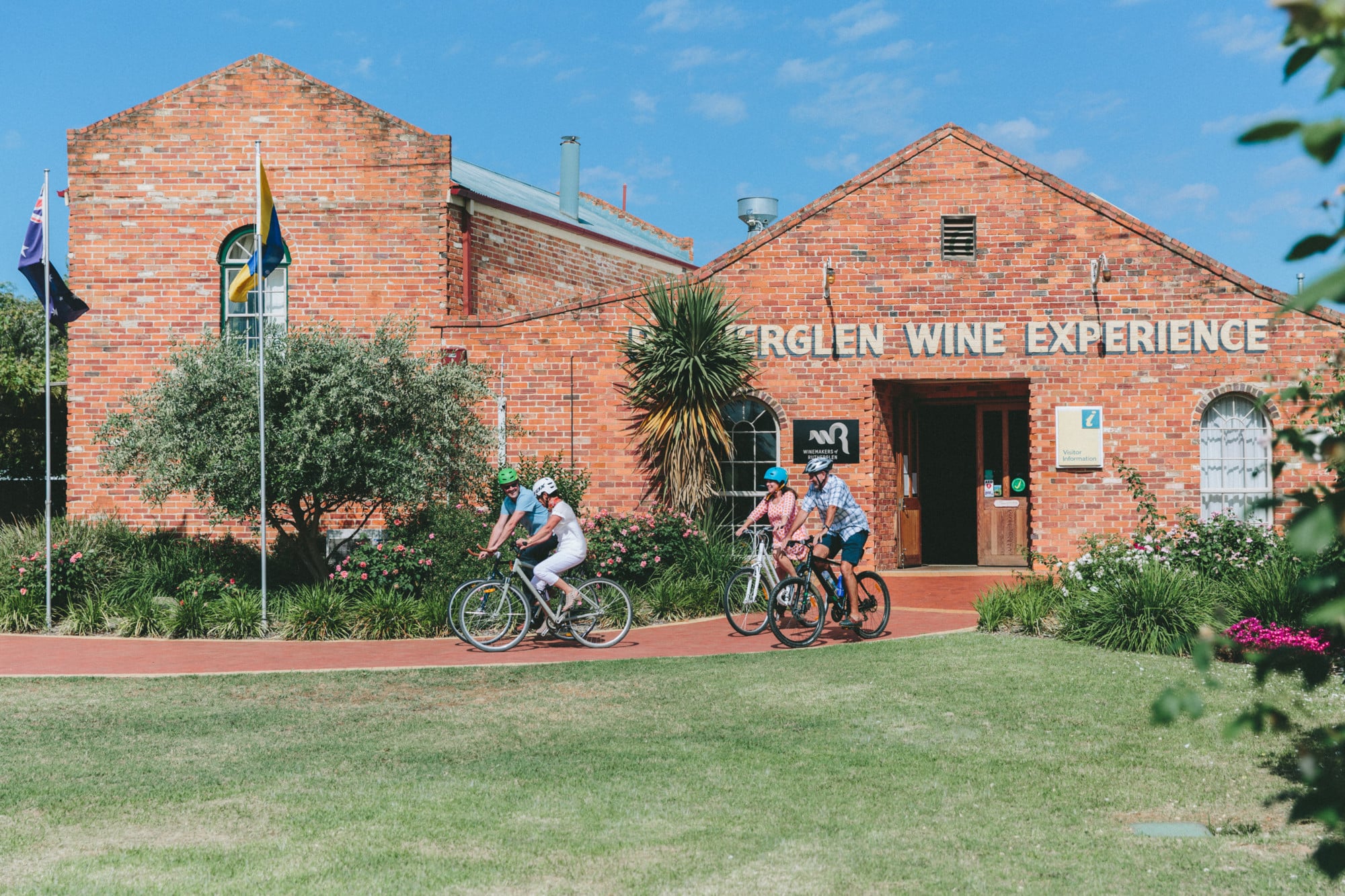 Group of cyclist pedalling away from the Rutherglen Visitor Information Centre